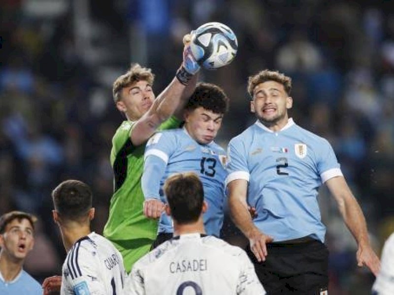 Pemain Uruguay berebut bola udara dengan pemain Italia. (int) 