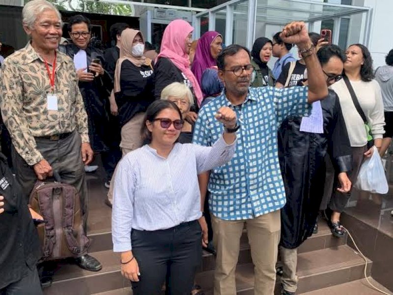 Haris Azhar dan Fatia Maulidiyanti mengangkat tangan usai divonis bebas. (int) 
