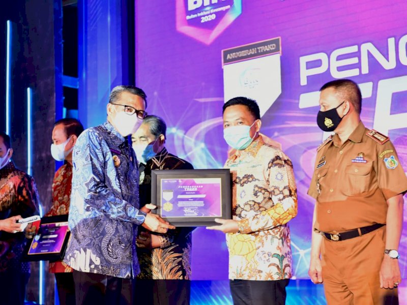 Ilham Azikin saat menerima penghargaan TPAKD yang diserahkan Nurdin Abdullah. 