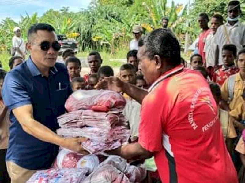 Cawabup Nabire Tabroni saat membagikan seragam ke SD Inpres Waroki. 