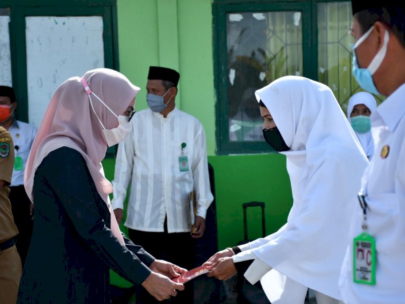 Bupati Lutra Indah Putri Indriani saat menyerahkan Karya Satyalancana ke pegawai Kemenag. 