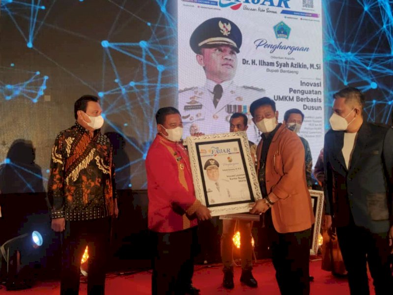 Bupati Torut Yohanis Bassang menerima award di HUT ke-40 Fajar.