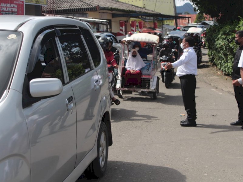 Bupati Torut Yohanis Bassang turun tangan mengatur kendaraan.
