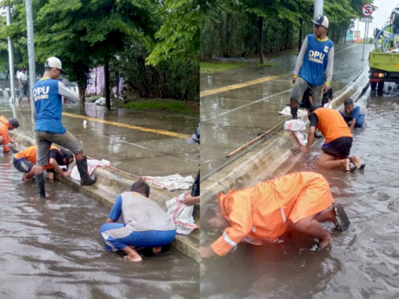 Tim Satgas Operasi dan Pemeliharaan (OP) Parrita Dinas PU Makassar mengatasi genangan. 
