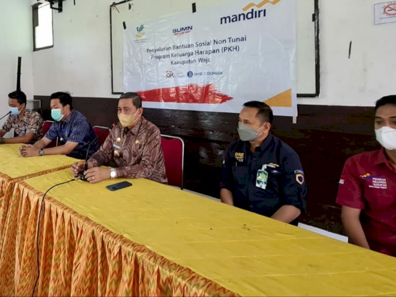 Bupati Wajo H Amran Mahmud disaksikan pejabat kecamatan Tempe dan para pendamping PKH menyerahkan bantuan non tunai kepada 73 kepala keluarga (ist)